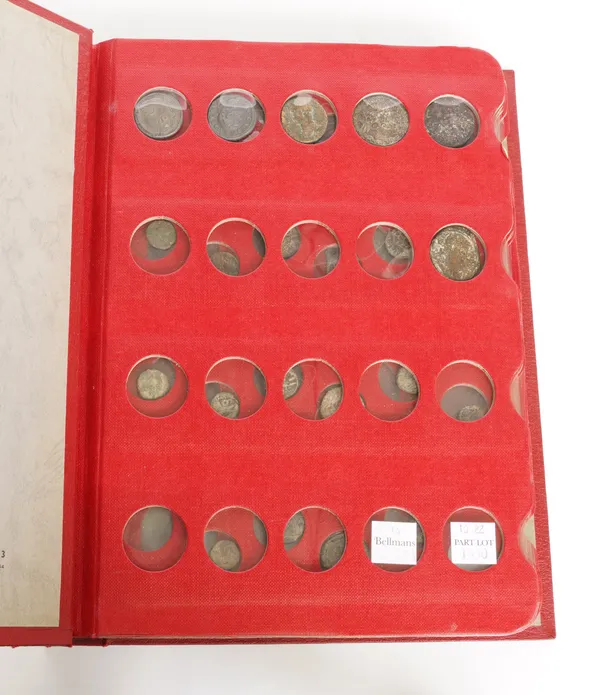 A COLLECTION OF COINS CONTAINED IN A RED COIN LIBRARY