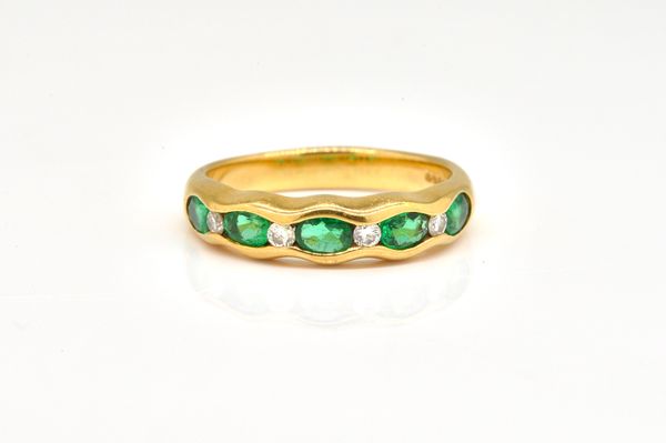 AN 18CT GOLD, EMERALD AND DIAMOND HALF HOOP RING