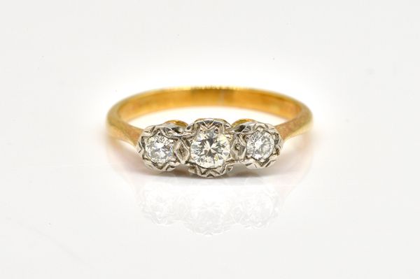 AN 18CT GOLD AND DIAMOND THREE STONE RING