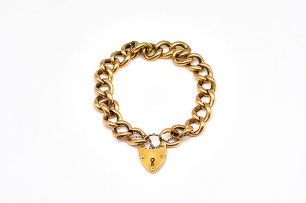 AN ANTIQUE GOLD CURB LINK BRACELET WITH A GOLD HEART SHAPED PADLOCK CLASP