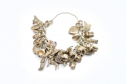 A SILVER CURB LINK CHARM BRACELET