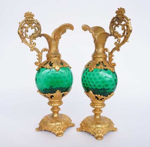 A PAIR OF FRENCH GILT SPELTER MOUNTED GREEN GLASS ORNAMENTAL EWERS (2)