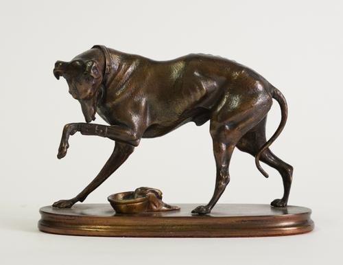 IN THE MANNER OF A.E VOGT (1811-1892): A BRONZE MODEL OF A WOUNDED GREYHOUND OR WHIPPET