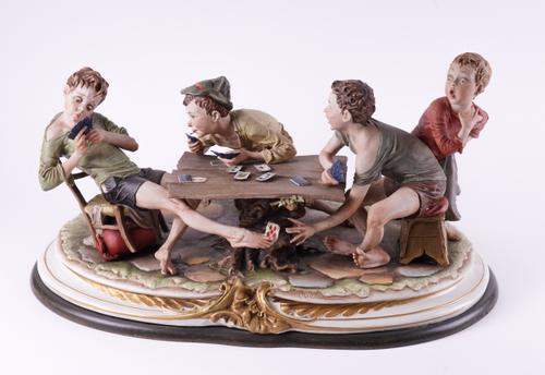 A CAPODIMONTE PORCELAIN FIGURAL GROUP ‘THE CHEAT’