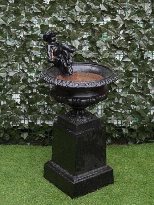 A 19TH CENTURY BLACK PAINTED CAST-IRON URN WITH CHERUB MOUNT