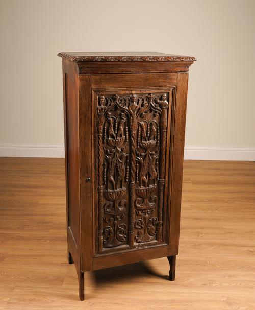 A GOTHIC CARVED OAK PANEL DEPICTING FIGURES AND BIRDS IN ARCHES