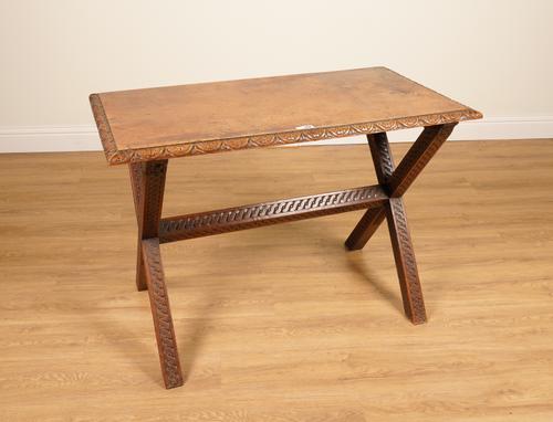 A 17TH CENTURY STYLE CARVED MAHOGANY SINGLE SLAB TOP TAVERN TABLE ON X-FRAME BASE