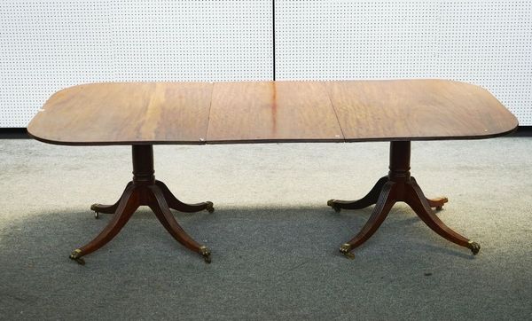A MAHOGANY D-END EXTENDING DINING TABLE