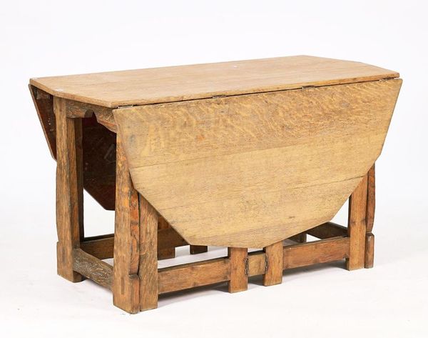 PROBABLY ‘AMBROSE HEAL’; AN EARLY 20TH CENTURY LIMED OAK DROP FLAP TABLE