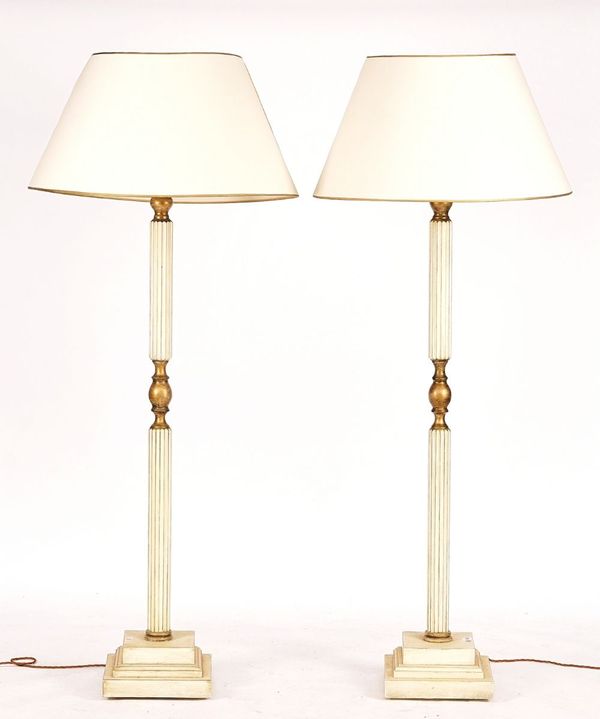 A PAIR OF 20TH CENTURY PARCEL GILT AND CREAM PAINTED STANDARD LAMPS (2)