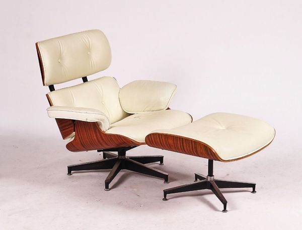 AFTER CHARLES AND RAY EAMES; A WALNUT AND CREAM LEATHER UPHOLSTERED LOUNGE CHAIR (2)