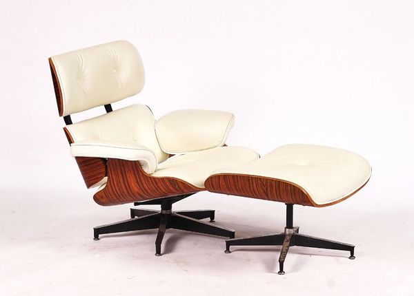 AFTER CHARLES AND RAY EAMES; A WALNUT AND CREAM LEATHER UPHOLSTERED LOUNGE CHAIR (2)