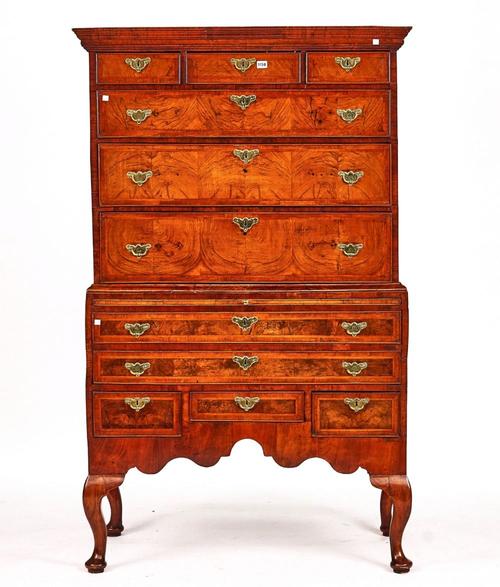 A GEORGE I HERRINGBONE BANDED FIGURED WALNUT CHEST ON STAND