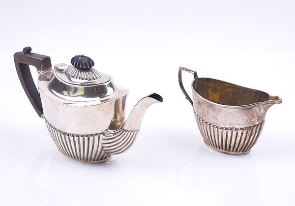 A SILVER TEAPOT AND A MATCHING MILK JUG (2)