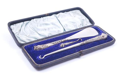 A VICTORIAN SILVER MOUNTED THREE PIECE BUTTON HOOK AND SHOE HORN SET