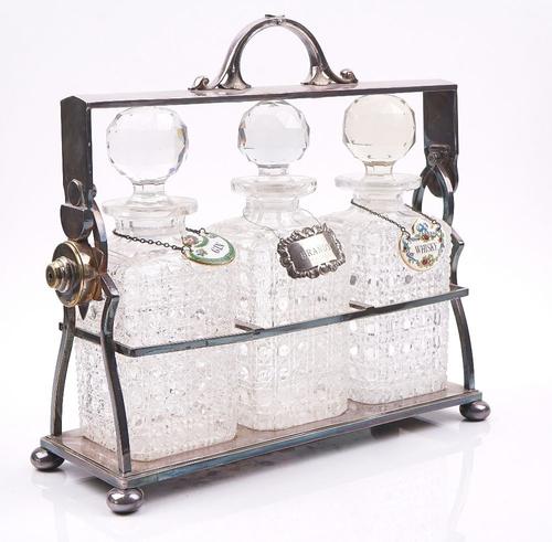 A PLATED THREE BOTTLE TANTALUS FRAME