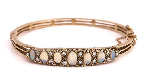 A 9CT GOLD, OPAL AND DIAMOND OVAL HINGED BANGLE