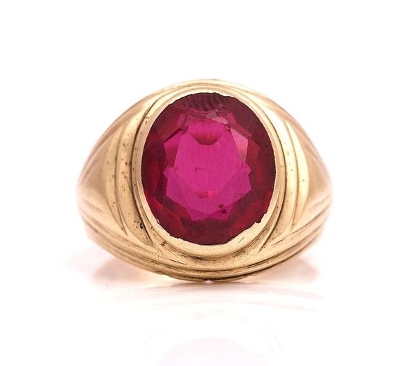 A GOLD AND SYNTHETIC RED GEM SET SOLITAIRE RING