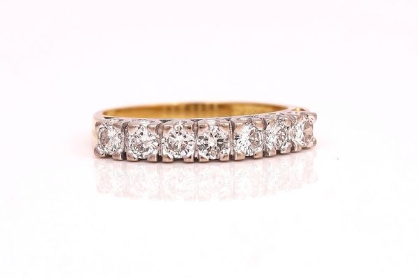 AN 18CT GOLD AND DIAMOND SEVEN STONE HALF HOOP RING