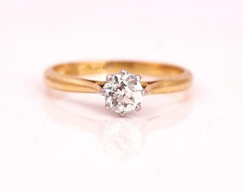 A GOLD AND PLATINUM DIAMOND SINGLE STONE RING