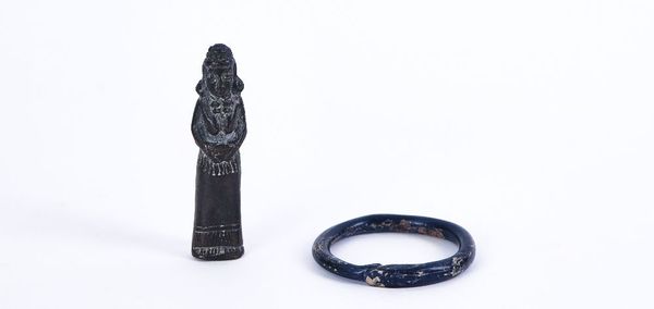 A ROMAN BLUE GLASS BANGLE AND A BRONZE AMULET, POSSIBLY INDIAN (2)