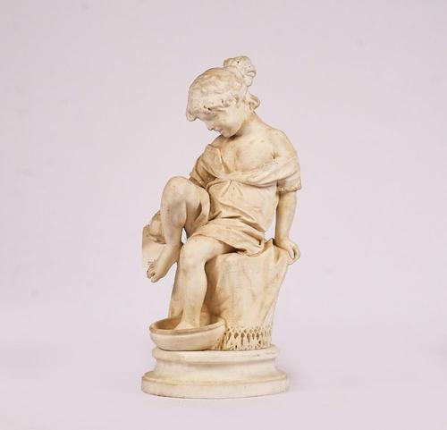 AN ITALIAN CARVED MARBLE FIGURE OF A SEATED YOUNG GIRL