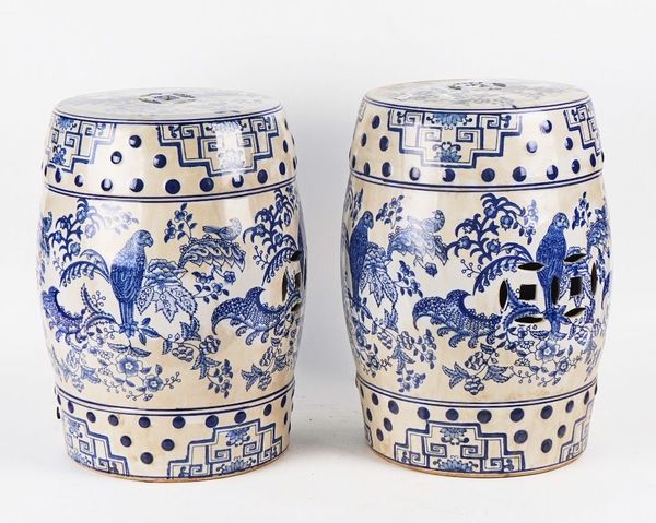 A PAIR OF CHINESE STYLE BLUE AND WHITE GLAZED CERAMIC BARREL SHAPED GARDEN SEATS (2)