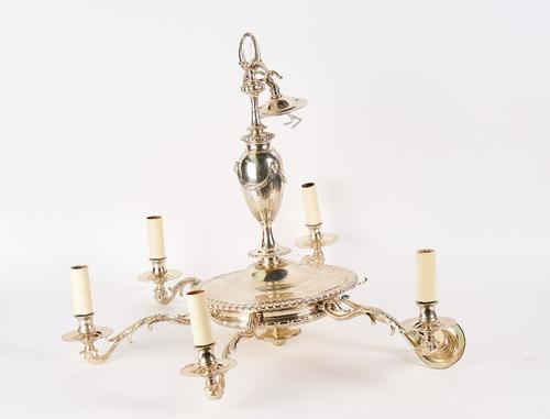 A SILVERED-METAL SIX LIGHT CHANDELIER