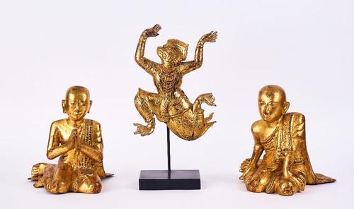 A PAIR OF SOUTH-EAST ASIAN GILTWOOD FIGURES OF KNEELING MONKS TOGETHER WITH A DANCING FIGURE (3)