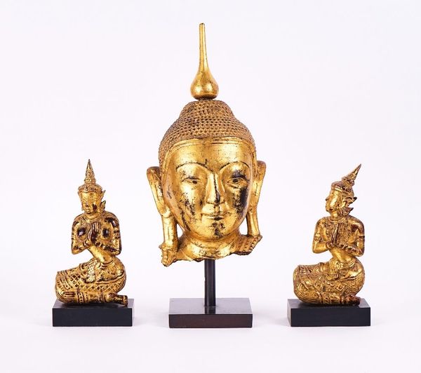 A SOUTH-EAST ASIAN GILT HEAD OF A BUDDHA  TOGETHER WITH A PAIR OF KNEELING FIGURES  (3)
