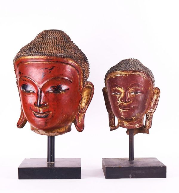 A SOUTH-EAST ASIAN CINNABAR LACQUER BUDDHA HEAD OF LARGE SIZE TOGETHER WITH ANOTHER