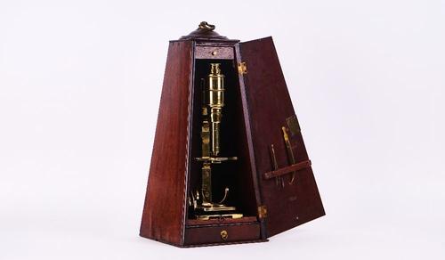 A BRASS CUFF-TYPE MICROSCOPE AND MAHOGANY PILLAR CASE