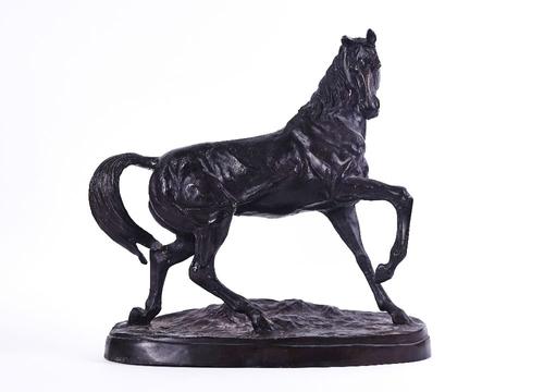 A PATINATED BRONZE SCULPTURE OF A HORSE