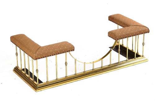 A BRASS AND UPHOLSTERED CLUB FENDER