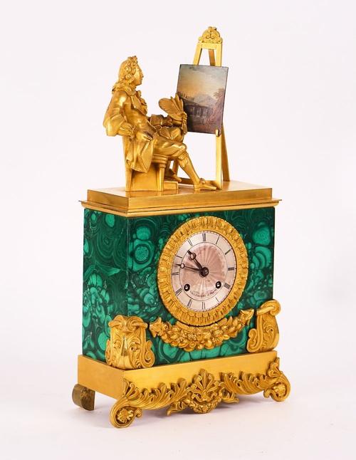 A RESTAURATION MALACHITE VENEERED ORMOLU MOUNTED  STRIKING MANTEL CLOCK