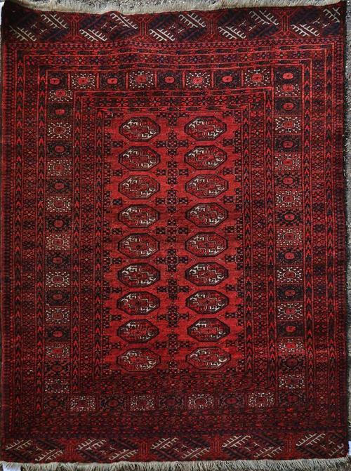 AN AFGHAN RUG, OF TURKMEN DESIGN