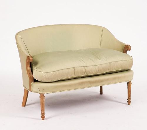 OKA; A SMALL BEECH FRAMED TUB BACK SOFA
