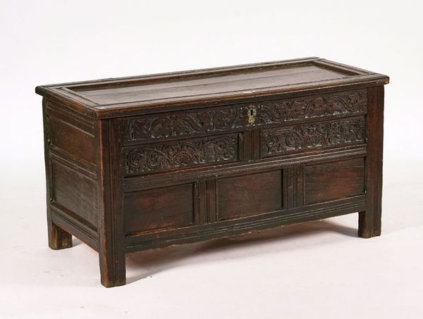 A CHARLES II CARVED AND JOINT OAK COFFER