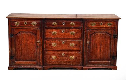 A GEORGE III OAK INVERTED BREAKFRONT DRESSER BASE