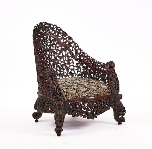 A 19TH CENTURY BURMESE HARDWOOD TUB BACK CHAIR