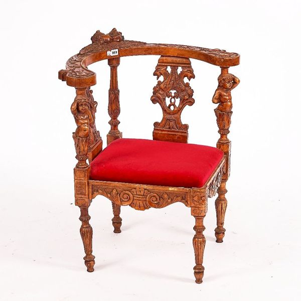 A 19TH CENTURY CONTINENTAL FIGURAL CARVED WALNUT CORNER CHAIR