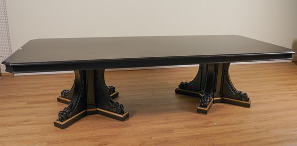 PROBABLY RALPH LAUREN; A LARGE EBONISED CANTED RECTANGULAR DINING TABLE ON DUAL LION’S PAW PEDESTALS