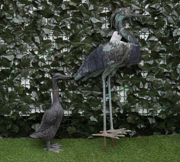 A CAST BRONZE FIGURE OF A STANDING HERON (2)