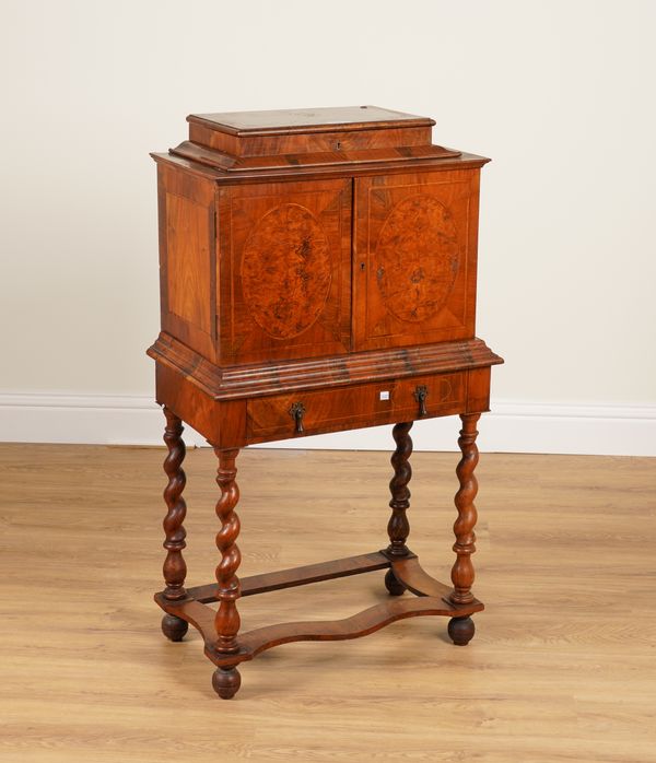 A 17TH CENTURY STYLE FIGURED WALNUT FITTED CABINET ON STAND