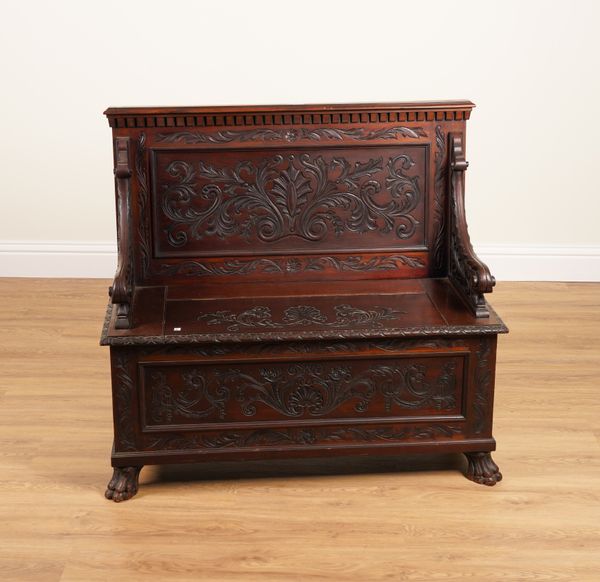 A 19TH CENTURY CARVED MAHOGANY BOX SEAT SETTLE