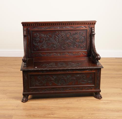 A 19TH CENTURY CARVED MAHOGANY BOX SEAT SETTLE