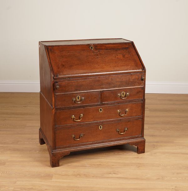 A SMALL EARLY 18TH CENTURY OAK STEPPED AND WELLED BUREAU