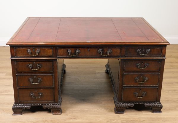 A LATE 19TH CENTURY CARVED MAHOGANY NINE DRAWER PEDESTAL PARTNER’S DESK