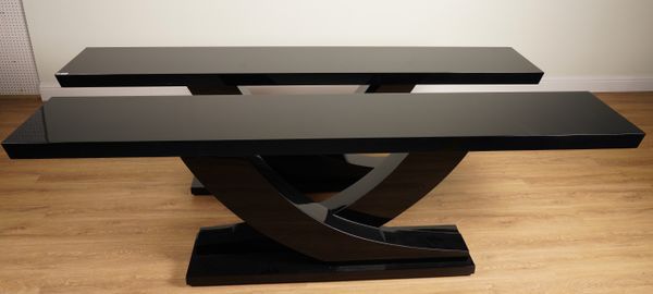 CHRISTOPHER GUY; A PAIR OF SERRA BLACK LACQUER RECTANGULAR CONSOLE TABLES ON OPPOSING DOWNSWEPT SUPPORTS (2)