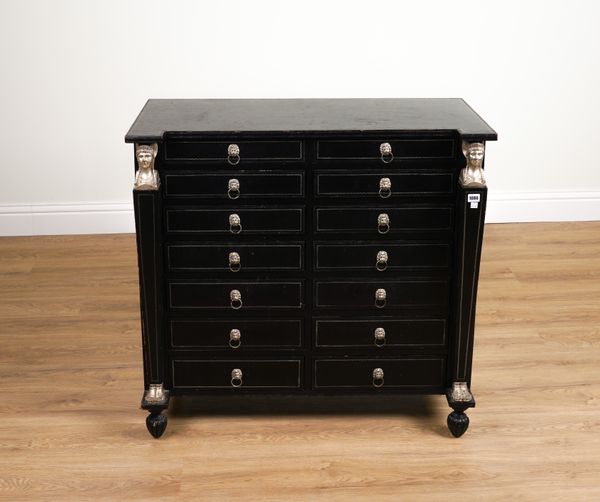 MAITLAND-SMITH; AN EBONISED AND LEATHER CARYATID MOUNTED FOURTEEN DRAWER SIDE CHEST